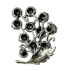 Vintage Hollycraft rhinestone brooch from the 1950s/60s featuring 10 multicolor rhinestone berries in blue, teal green, and dark amethyst hues on silver-tone branches, accented by