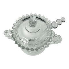 A vintage Imperial Candlewick pattern glass condiment jar set, featuring a handled jar, a fitted glass lid, and a matching glass spoon. Made between 1936 and 1984, the set is in excellent vintage condition and showcases the iconic bead design of the Candlewick collection.