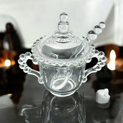 A vintage Imperial Candlewick pattern glass condiment jar set, featuring a handled jar, a fitted glass lid, and a matching glass spoon. Made between 1936 and 1984, the set is in excellent vintage condition and showcases the iconic bead design of the Candlewick collection.