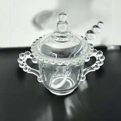 A vintage Imperial Candlewick pattern glass condiment jar set, featuring a handled jar, a fitted glass lid, and a matching glass spoon. Made between 1936 and 1984, the set is in excellent vintage condition and showcases the iconic bead design of the Candlewick collection.