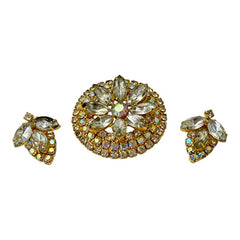 Verified Juliana #1402 vintage clear rhinestone and gold-tone floral brooch with matching clip-on earrings. The brooch features dimensional layered rings of clear chaton and AB rhinestones, with marquise rhinestones encircling the center. Earrings showcase a leaf-shaped design with marquise rhinestones and AB chaton accents. Mid-century elegance from the late 1950s or early 1960s.