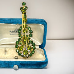 Vintage Juliana violin brooch in gold tone metal with green and peridot rhinestones, featuring layered construction and floral accents; verified design #3151 from the 1960s, shown from front and back.