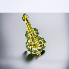 Vintage Juliana violin brooch in gold tone metal with green and peridot rhinestones, featuring layered construction and floral accents; verified design #3151 from the 1960s, shown from front and back.