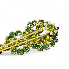 Vintage Juliana violin brooch in gold tone metal with green and peridot rhinestones, featuring layered construction and floral accents; verified design #3151 from the 1960s, shown from front and back.