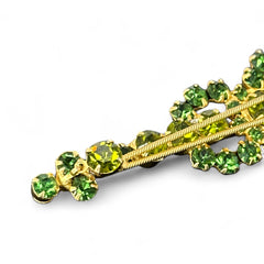 Vintage Juliana violin brooch in gold tone metal with green and peridot rhinestones, featuring layered construction and floral accents; verified design #3151 from the 1960s, shown from front and back.