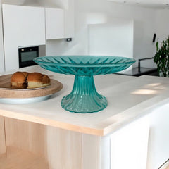 A vibrant aqua blue pressed glass footed dish with a diamond pattern, versatile for serving desserts, fruit, or candy, mid-century design.