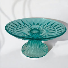 A vibrant aqua blue pressed glass footed dish with a diamond pattern, versatile for serving desserts, fruit, or candy, mid-century design.