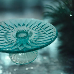 A vibrant aqua blue pressed glass footed dish with a diamond pattern, versatile for serving desserts, fruit, or candy, mid-century design.