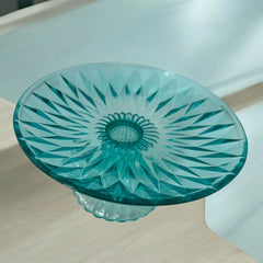A vibrant aqua blue pressed glass footed dish with a diamond pattern, versatile for serving desserts, fruit, or candy, mid-century design.