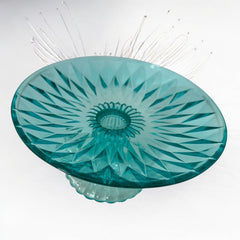 A vibrant aqua blue pressed glass footed dish with a diamond pattern, versatile for serving desserts, fruit, or candy, mid-century design.
