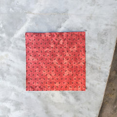 Provence cotton napkins featuring a rust orange background with red and yellow floral designs from Marat d’Avignon Tradition Collection, made of 100% cotton, measuring 18" x 18", with vibrant, fade-resistant prints. Made in France.