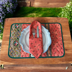 Provence cotton napkins featuring a rust orange background with red and yellow floral designs from Marat d’Avignon Tradition Collection, made of 100% cotton, measuring 18" x 18", with vibrant, fade-resistant prints. Made in France.