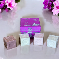 Fuchsia toile de Jouy gift box with intricate patterns, containing four artisanal Marseille cube soaps in Fig, Jasmine, Rose, and Lily of the Valley fragrances.