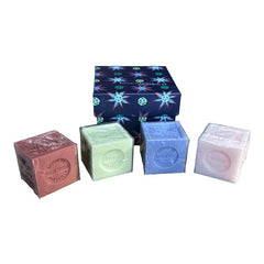 Gift box featuring a charming Moon and Sun design on a midnight blue background. Contains four artisanal Marseille cube soaps in Violet, Rose, Verbena, and Red Berries fragrances.