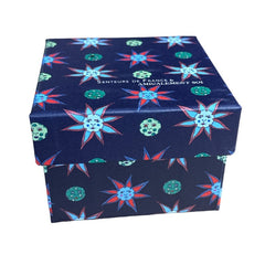 Gift box featuring a charming Moon and Sun design on a midnight blue background. Contains four artisanal Marseille cube soaps in Violet, Rose, Verbena, and Red Berries fragrances.