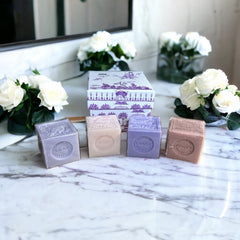 Purple Toile de Jouy gift box featuring intricate patterns, containing four artisanal Marseille cube soaps in Lilac, Lavender, Fig, and Rose fragrances.