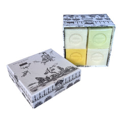 Gray Toile de Jouy gift box with intricate patterns, containing four artisanal Marseille cube soaps in Honeysuckle, Almond, Verbena, and Jasmine fragrances.