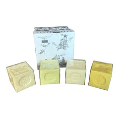 Gray Toile de Jouy gift box with intricate patterns, containing four artisanal Marseille cube soaps in Honeysuckle, Almond, Verbena, and Jasmine fragrances.