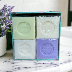 Green Toile de Jouy gift box featuring intricate patterns, containing four artisanal Marseille cube soaps in Lily of the Valley, Lavender, Verbena, and Jasmine fragrances.