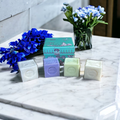 Green Toile de Jouy gift box featuring intricate patterns, containing four artisanal Marseille cube soaps in Lily of the Valley, Lavender, Verbena, and Jasmine fragrances.