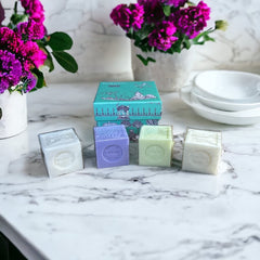Green Toile de Jouy gift box featuring intricate patterns, containing four artisanal Marseille cube soaps in Lily of the Valley, Lavender, Verbena, and Jasmine fragrances.