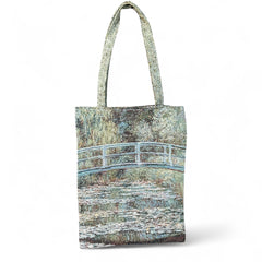 Tapestry tote bag featuring Monet’s Japanese Bridge and Water Lilies, woven in France with soft green, blue, and pink tones; double-sided print with long handles, inspired by Impressionist art.