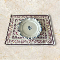 Provence Jacquard Montespan Collection placemat from Tissus Toselli, featuring a pink floral design on a cream-colored background, woven with intricate patterns inspired by old Provencal fabrics, measuring 19" x 15", photographed showcasing its elegant and refined craftsmanship