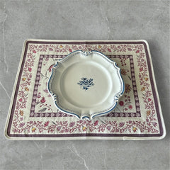 Provence Jacquard Montespan Collection placemat from Tissus Toselli, featuring a pink floral design on a cream-colored background, woven with intricate patterns inspired by old Provencal fabrics, measuring 19" x 15", photographed showcasing its elegant and refined craftsmanship