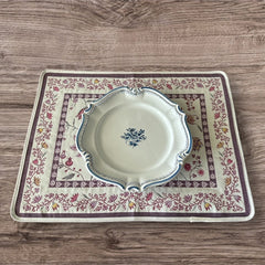 Provence Jacquard Montespan Collection placemat from Tissus Toselli, featuring a pink floral design on a cream-colored background, woven with intricate patterns inspired by old Provencal fabrics, measuring 19" x 15", photographed showcasing its elegant and refined craftsmanship
