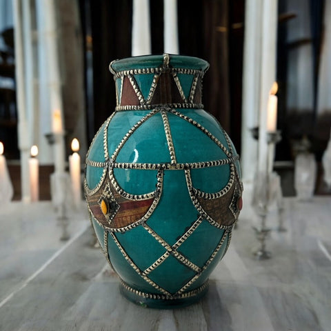 Vintage Moroccan round vase with green glaze, featuring geometric metal decor, four dyed leather inlays with yellow or red bezel-set glass cabochons at their center, and triangle-shaped leather accents around the top, from the 1970s/80s in very good condition.