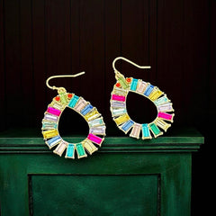 Christian Siriano New York teardrop dangle earrings with multicolor baguette-cut cubic zirconia stones in a vibrant, symmetrical design.