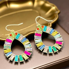 Christian Siriano New York teardrop dangle earrings with multicolor baguette-cut cubic zirconia stones in a vibrant, symmetrical design.