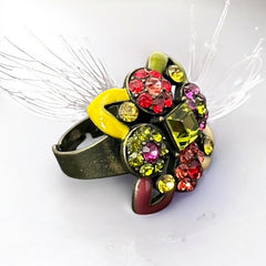 Adjustable brass ring with multicolor enamel leaves and rhinestone floral motifs, featuring vibrant hues of red, pink, green, purple, moss green, cream, and yellow, in very good second-hand condition.