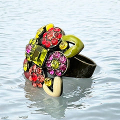 Adjustable brass ring with multicolor enamel leaves and rhinestone floral motifs, featuring vibrant hues of red, pink, green, purple, moss green, cream, and yellow, in very good second-hand condition.