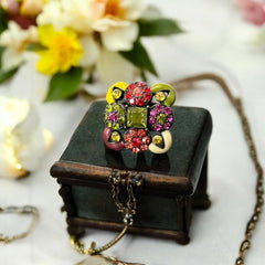 Adjustable brass ring with multicolor enamel leaves and rhinestone floral motifs, featuring vibrant hues of red, pink, green, purple, moss green, cream, and yellow, in very good second-hand condition.