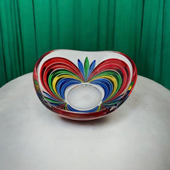 A small, triangular vintage Murano glass trinket dish from the 1990s, featuring vibrant red, green, blue, and yellow colors. The multicolored Venetian glass dish has a tiny chip on the rim but remains a striking and functional decorative piece.