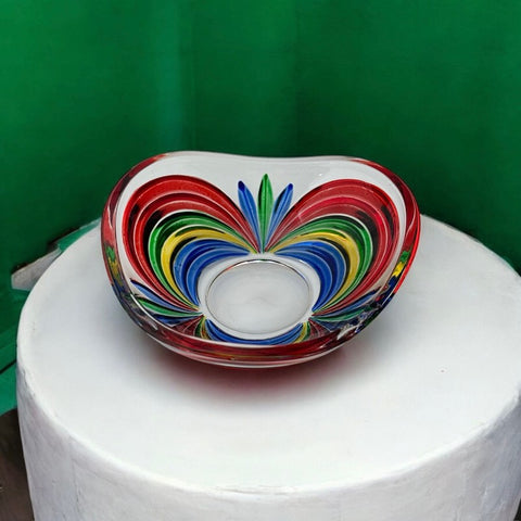 A small, triangular vintage Murano glass trinket dish from the 1990s, featuring vibrant red, green, blue, and yellow colors. The multicolored Venetian glass dish has a tiny chip on the rim but remains a striking and functional decorative piece.