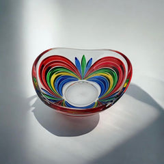 A small, triangular vintage Murano glass trinket dish from the 1990s, featuring vibrant red, green, blue, and yellow colors. The multicolored Venetian glass dish has a tiny chip on the rim but remains a striking and functional decorative piece.