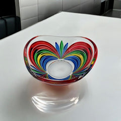 A small, triangular vintage Murano glass trinket dish from the 1990s, featuring vibrant red, green, blue, and yellow colors. The multicolored Venetian glass dish has a tiny chip on the rim but remains a striking and functional decorative piece.