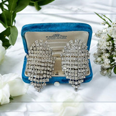 Pair of vintage 1950s Musi clear rhinestone chain shoe clips with an elongated shape, featuring triangular details at the top and bottom. The top rhinestone chains are soldered, while the bottom section moves for added sparkle. Signed 'Musi' on the back, in very good vintage condition with one slightly darkened rhinestone.