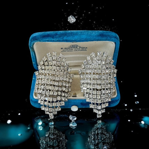 Pair of vintage 1950s Musi clear rhinestone chain shoe clips with an elongated shape, featuring triangular details at the top and bottom. The top rhinestone chains are soldered, while the bottom section moves for added sparkle. Signed 'Musi' on the back, in very good vintage condition with one slightly darkened rhinestone.
