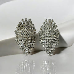 Pair of vintage 1950s Musi clear rhinestone chain shoe clips with an elongated shape, featuring triangular details at the top and bottom. The top rhinestone chains are soldered, while the bottom section moves for added sparkle. Signed 'Musi' on the back, in very good vintage condition with one slightly darkened rhinestone.