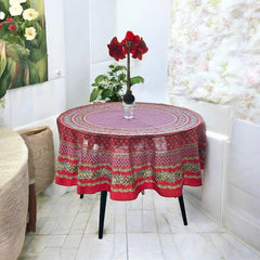 Round Provence-style cotton tablecloth by Le Cluny, featuring a vibrant red background with yellow mimosa and black olive detailing. Measures 70 inches in diameter, made in France, suitable for indoor and outdoor use, and machine washable for easy care.