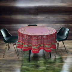 Round Provence-style cotton tablecloth by Le Cluny, featuring a vibrant red background with yellow mimosa and black olive detailing. Measures 70 inches in diameter, made in France, suitable for indoor and outdoor use, and machine washable for easy care.