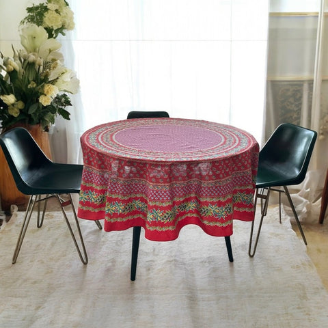 Round Provence-style cotton tablecloth by Le Cluny, featuring a vibrant red background with yellow mimosa and black olive detailing. Measures 70 inches in diameter, made in France, suitable for indoor and outdoor use, and machine washable for easy care.