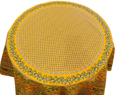Round Provence-style cotton tablecloth by Le Cluny, featuring a vibrant yellow background with detailed mimosa and black olive patterns. Measures 70 inches in diameter, made in France, suitable for indoor and outdoor use, and machine washable for easy care.
