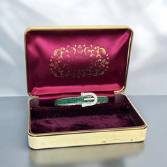 Emerald and clear rhinestone hinged bangle bracelet made of polished stainless steel with a modern belt buckle design, featuring sparkling accents and marked 316L S.Steel, photographed in excellent condition.