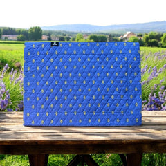 Reversible quilted cotton placemat in Bastide Blue Yellow by Marat d’Avignon, featuring a bold blue floral diamond motif with yellow paisley borders on the front, and a blue background with golden yellow medallions on the reverse, crafted in Provence.