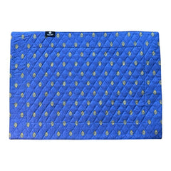 Reversible quilted cotton placemat in Bastide Blue Yellow by Marat d’Avignon, featuring a bold blue floral diamond motif with yellow paisley borders on the front, and a blue background with golden yellow medallions on the reverse, crafted in Provence.