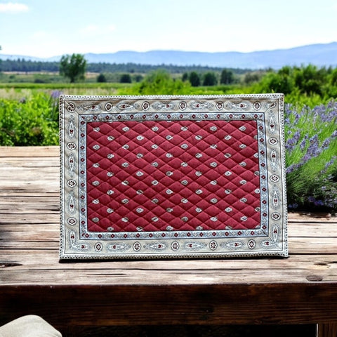 Reversible quilted cotton placemat in Bastide Red Grey by Marat d’Avignon, featuring a deep red floral diamond motif with ornate grey paisley borders on the front, and a delicate red-and-white floral pattern on the reverse, crafted in Provence.